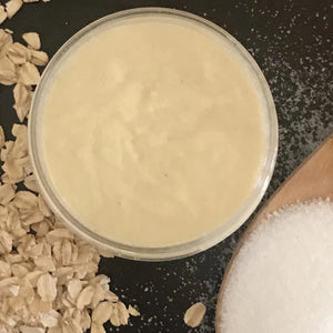Oat milk sugar scrub formula in jar with oats and sugar