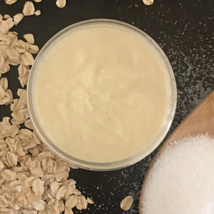 Oat milk sugar scrub formula in jar with oats and sugar